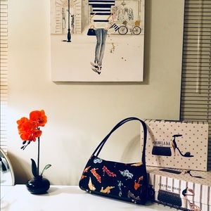 Hand bag black with shoe designs.